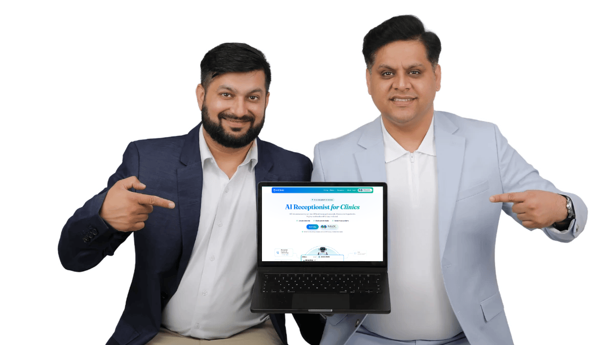 Dr. Varun Bajaj and Danish Wadhwa, co-founders of HiClinic, holding a laptop showing the HiClinic website